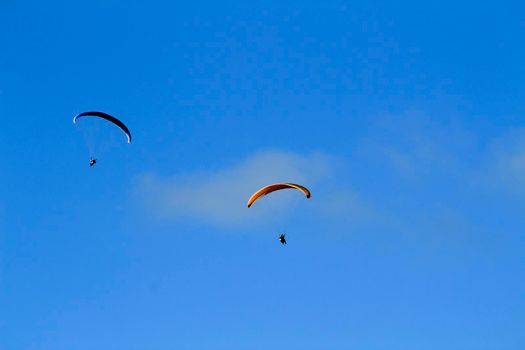 People paragliding in Santa Pola on a sunny day of Autumn
