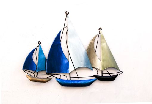 Three Blue decorative boats on a white wall