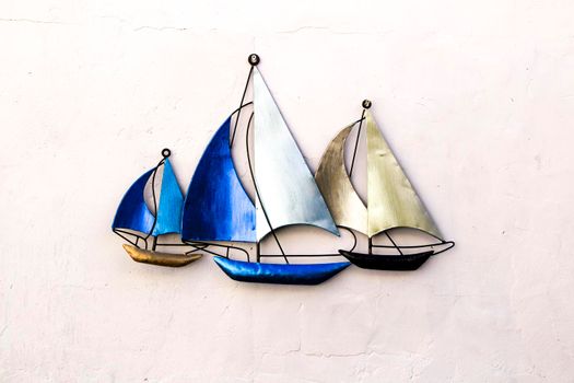 Three Blue decorative boats on a white wall