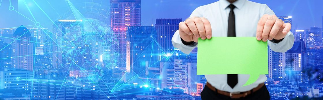 Man Wearing Black Tie Holding Chat Box Around Futuristic Technology.