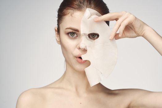 woman with bare shoulders and face mask skin care cosmetics. High quality photo