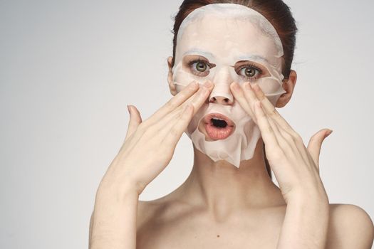 emotional woman cosmetic face mask close-up light background. High quality photo