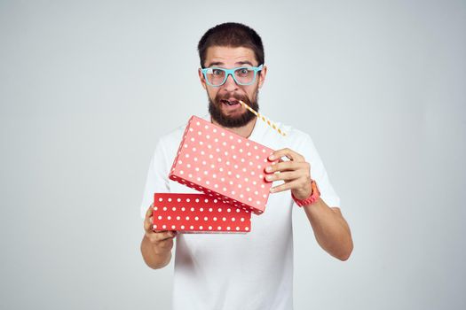 Cheerful man with gift in glasses holiday lifestyle fashion surprise. High quality photo