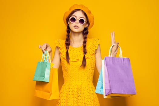 smiling woman in a yellow hat Shopaholic fashion style isolated background. High quality photo