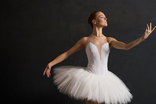 ballerina in a white tutu dance performance silhouette dark background. High quality photo