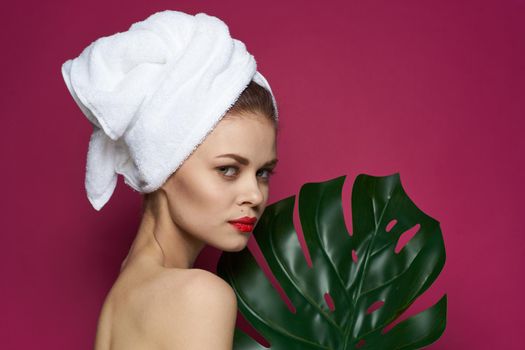 pretty woman bare shoulders red lips posing pink background. High quality photo