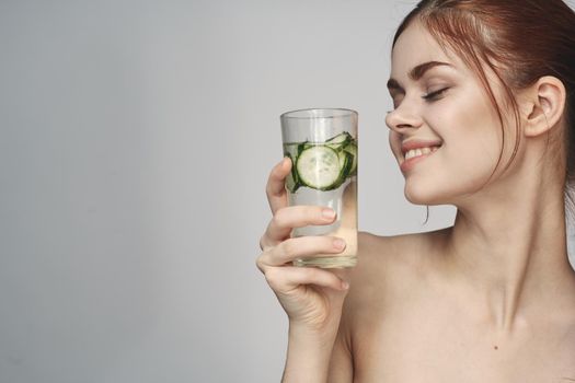 woman with cucumber drink health vitamins close-up. High quality photo