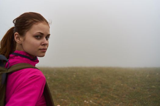 women in nature with a backpack in the mountains fog nature. High quality photo