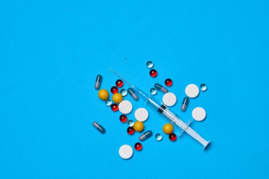 pain reliever Pharmaceuticals medicines syringe blue background. High quality photo