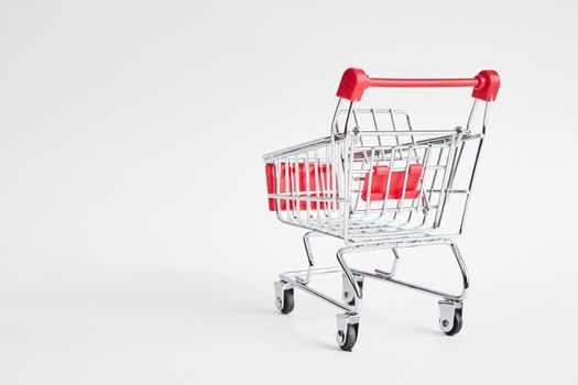 empty trolley on light background shopping supermarket service. High quality photo