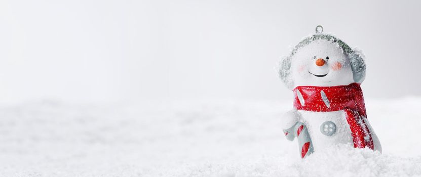 Festive Christmas background with snowman on snow, banner with copy space for text