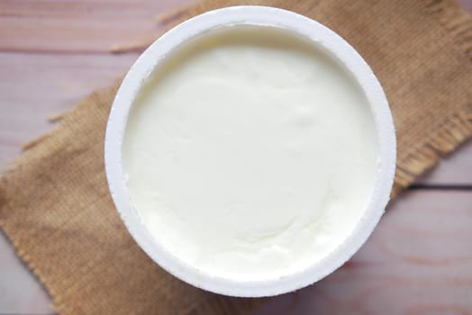 fresh yogurt in a bowl on table .