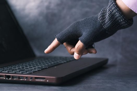 hacker hand stealing data from laptop .