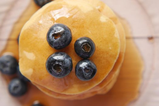 Pancakes with fresh berries and maple syrup on a plate