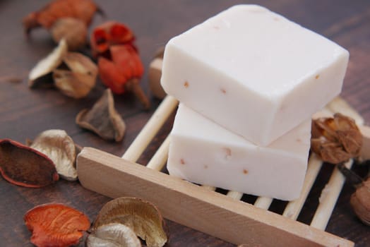 Homemade natural soap bar on black background .