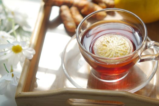 Top view of ginger tea on wooden background..