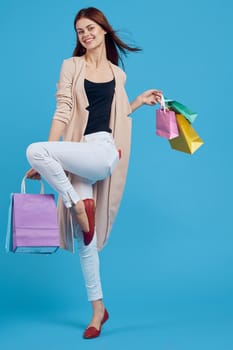 pretty woman with multicolored bags posing isolated background. High quality photo