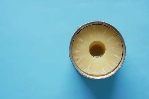 a open can of pineapple on table with copy space ,