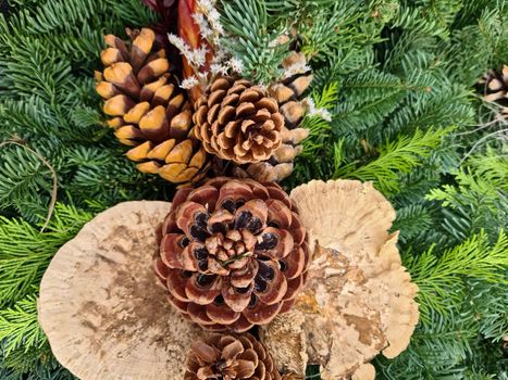 Selective focus of a beautiful arrangement of fir branches and cones at Christmas time