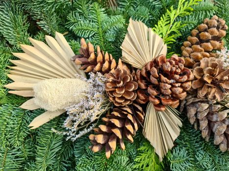 Selective focus of a beautiful arrangement of fir branches and cones at Christmas time