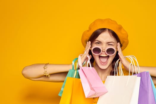 smiling woman in a yellow hat Shopaholic fashion style isolated background. High quality photo