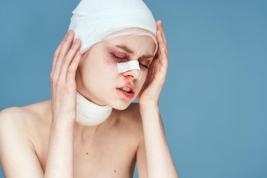 portrait of a woman bandaged face bruises bare shoulders discontent studio lifestyle. High quality photo