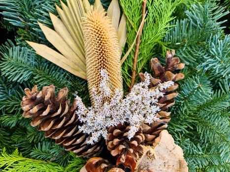 Selective focus of a beautiful arrangement of fir branches and cones at Christmas time