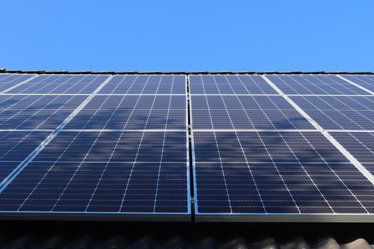 Solar panels producing clean energy on a roof of a residential house