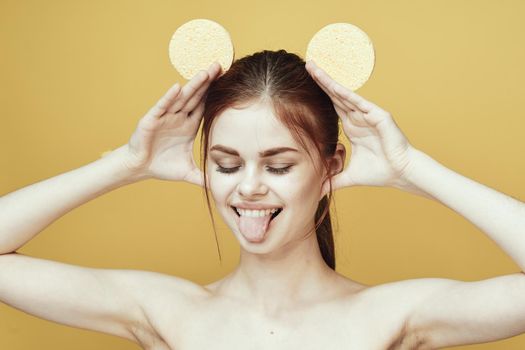 pretty woman with sponges in her hands bare shoulders clean skin hygiene. High quality photo