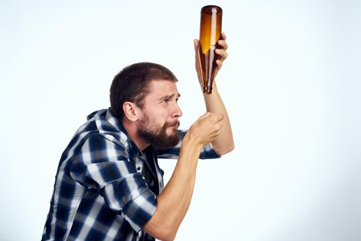 a man in a plaid shirt beer alcohol emotions fun light background. High quality photo