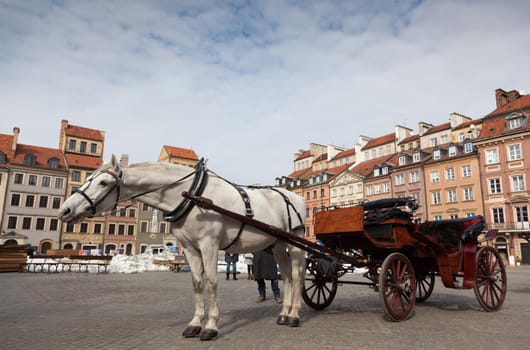 Horse-drawn carriage in front of the Old Town in Warsaw, Poland.