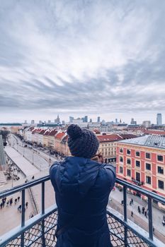 Tourist looking the Warsaw City Center from the tower during winter season.