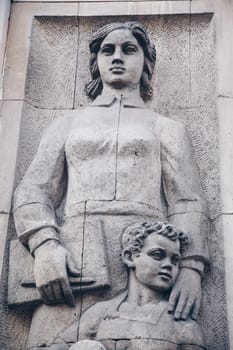 WARSAW, POLAND - March 2018 - A social realist relief of a socialist woman and kid in the center of Polish capital