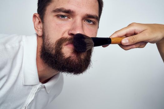 bearded man makeup cosmetics skin care light background. High quality photo