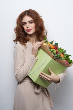 beautiful woman fun posing fruit bouquet vitamins light background. High quality photo