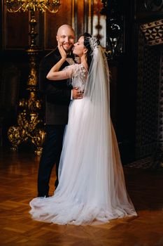 Elegant wedding couple in the interior of the old castle in the city of Nesvizh.