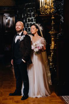 Elegant wedding couple in the interior of the old castle in the city of Nesvizh.