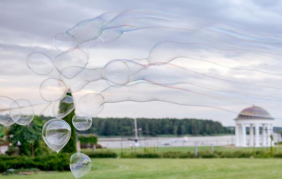 concept, soap bubbles as sperm fly to the left against the sky . High quality photo