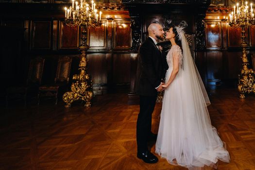 Elegant wedding couple in the interior of the old castle in the city of Nesvizh.