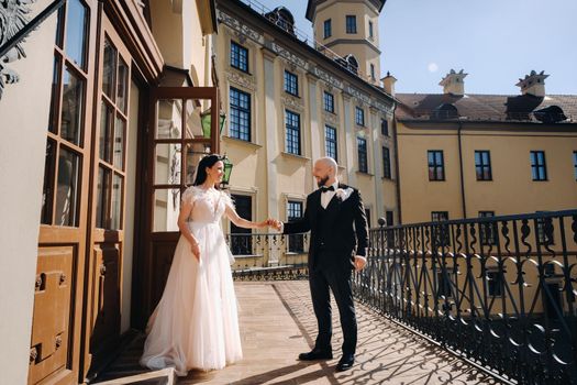 Elegant wedding couple on the balcony of an old castle in the city of Nesvizh.