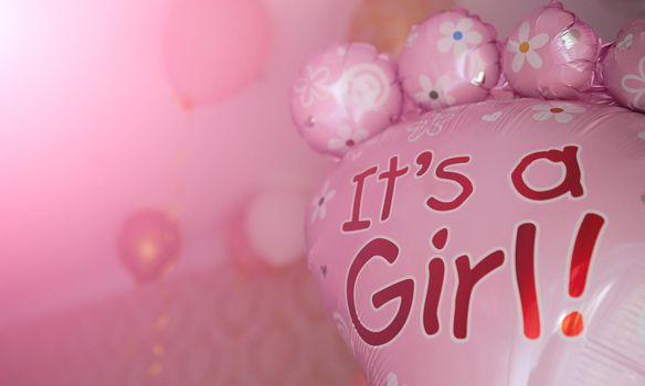 Pink balloon with text it's a girl gender reveal party. Gender party. High quality photo