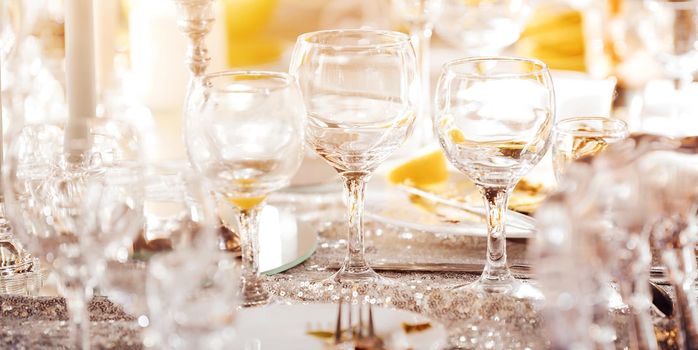 Beautiful festive table of luxury plates, glasses and cutlery served for wine tasting. Close up, blur background. High quality photo