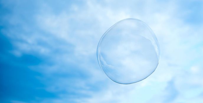 big soap bubble. The sky is light cloudy. High quality photo