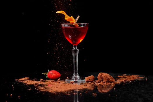 cocktail with strawberries and cocoa on a black background and a mirror table . High quality photo