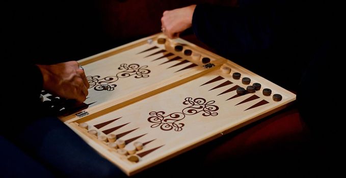 Senior couple playing classical backgammon, club evening . High quality photo