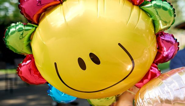 Yellow balloon with smile look like sunny . High quality photo