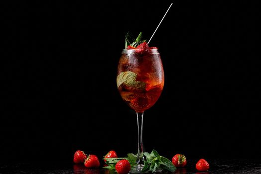 Cocktail in a glass with a tube on a black background with mint. High quality photo