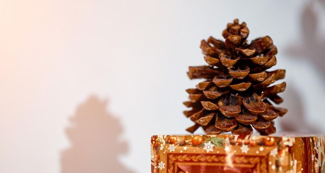 closeup big cone on holiday Christmas box table. High quality photo