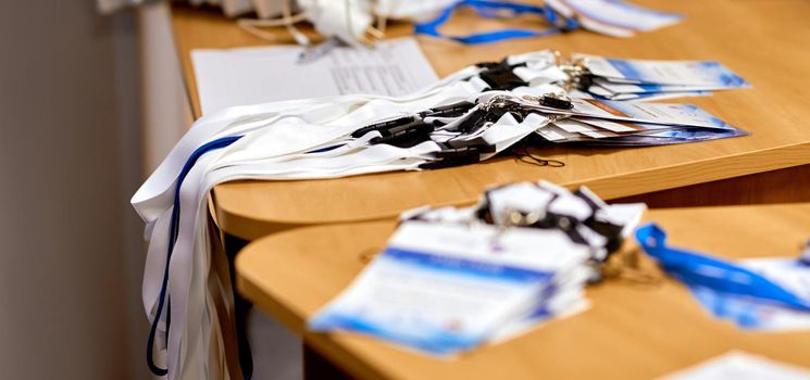 business conference. A stack of badges lies on the edge of the table for the participants' staff. High quality photo