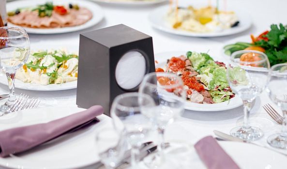 table with salads, glasses, napkins and napkins . High quality photo